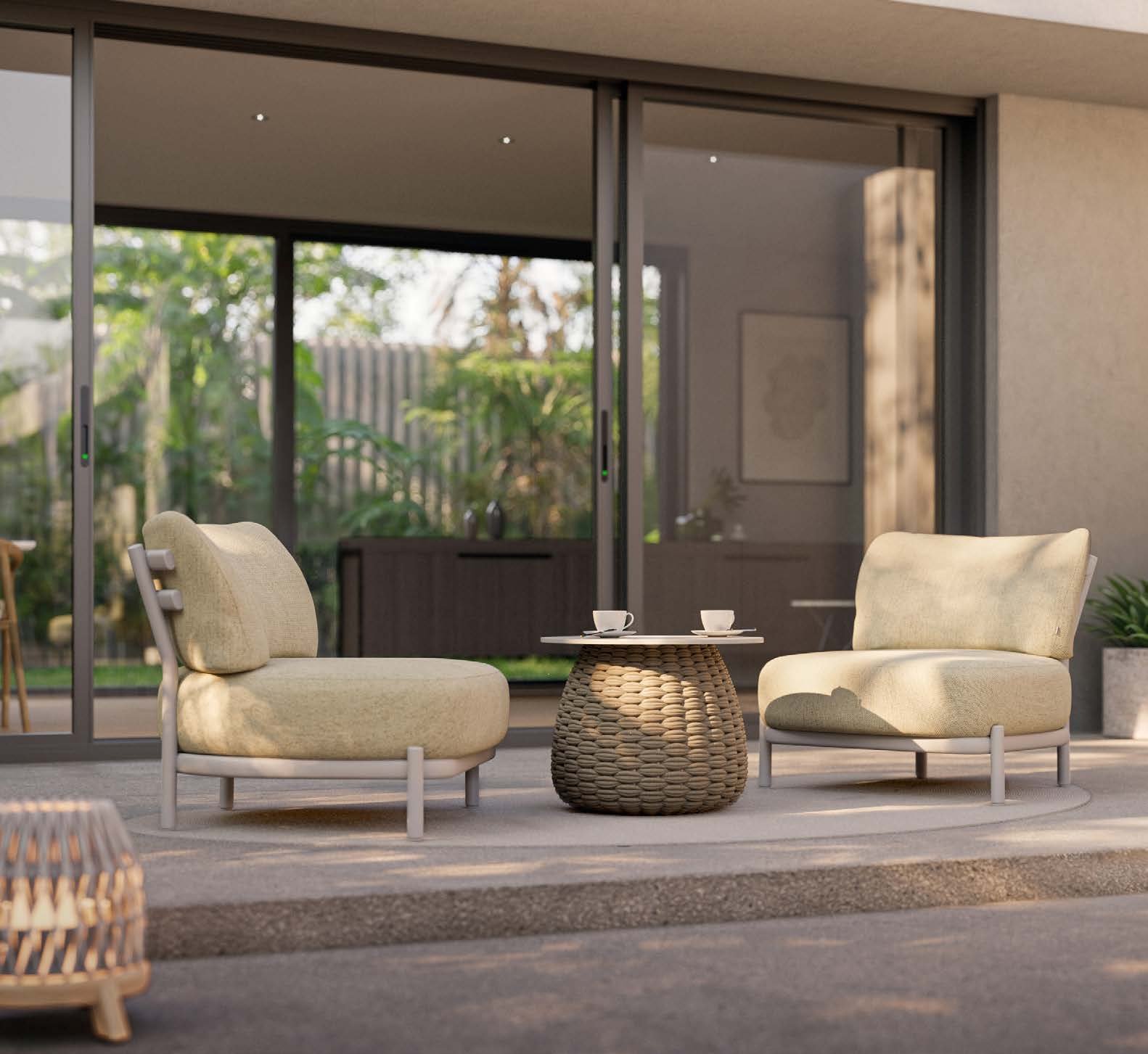 Manutti Alune lounge chairs with a Kobo coffee table on a stone terrace.